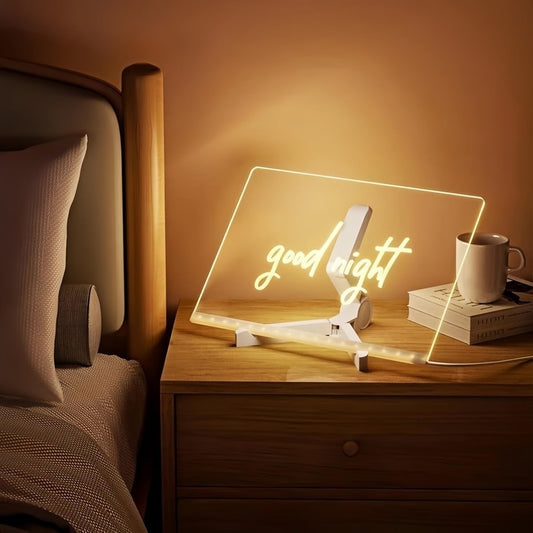 Neon sign saying 'good night' on a bedside table with a cup and books in a cozy bedroom.