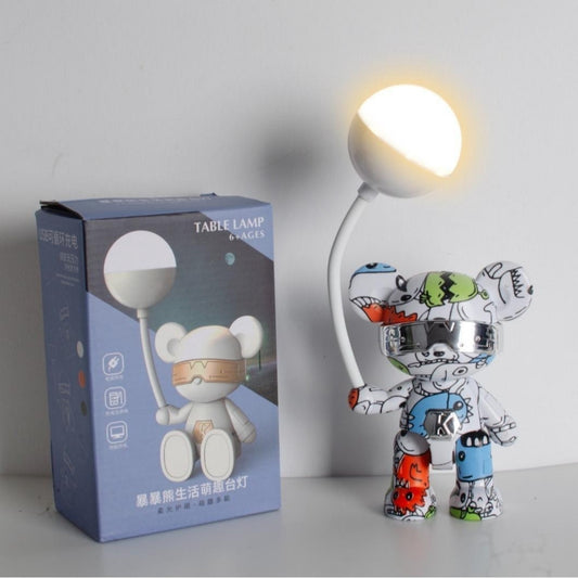 Table lamp with cartoon stand position design next to its packaging on a light gray background