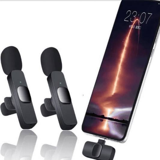 Two black microphone devices on a white background with a smartphone displaying a rocket launch screen.